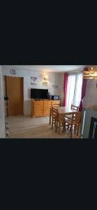 a living room with a table and a dining room at Casse blanche in Orcières
