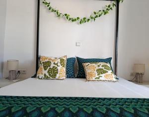 a bedroom with a bed with pillows on it at Villa DOUDOU in Somone +26 photos