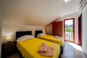 two beds in a room with a window at Rezidence Castello in Korčula +194 photos