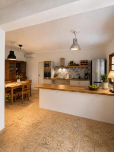a large kitchen with a counter and a table at Pangea Corfu Villa in Sidari