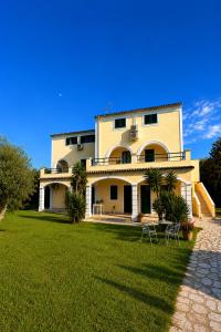a large house with a lawn in front of it at Pangea Corfu Villa in Sidari