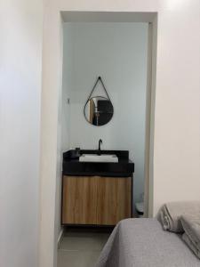 a bathroom with a sink and a mirror at Loft Vip RR in Boa Vista