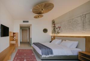 a bedroom with a large white bed with a red rug at Buknari Hotel in Buknari +28 photos