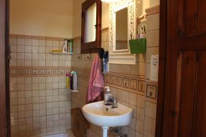 a bathroom with a sink and a mirror at Casa Llorens in Denia
