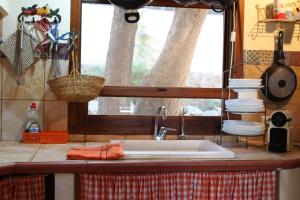 a kitchen counter with a sink and a window at Casa Llorens in Denia