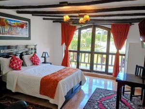 a bedroom with a bed and a large window at Hotel Villa de Paris in Chachapoyas +31 photos