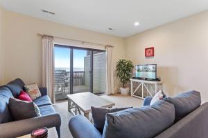 a living room with a couch and a tv at SW6 - Seawalk 6 in Kill Devil Hills
