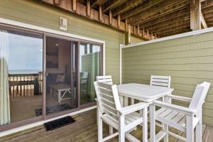 a table and chairs on the porch of a house at SW6 - Seawalk 6 in Kill Devil Hills +28 photos