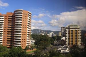 a view of a city with tall buildings at Hotel Las Americas in Guatemala