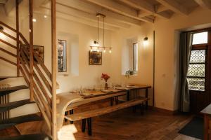 a dining room with a long table and a staircase at Moulin de Micheline - Jacuzzi - Vue Exceptionnelle in Bourg-dʼIré