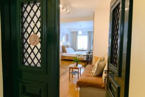a living room with a green door and a couch at BougainVilla in Vonitsa