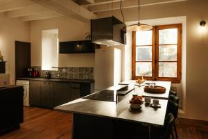 a kitchen with a large island in the middle of it at Moulin de Micheline - Jacuzzi - Vue Exceptionnelle in Bourg-dʼIré +27 photos