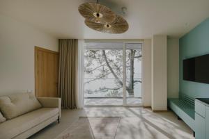 a living room with a couch and a large window at Buknari Hotel in Buknari