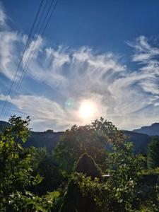 a view of the sun setting over the forest at Ferienwohnung Edith-Maria in Bad Goisern