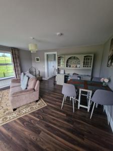 a living room with a couch and a table at Tully View House in Donegal