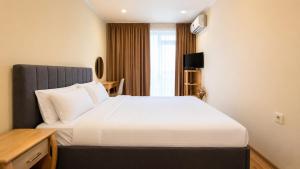 a hotel room with a bed and a window at Boris Garden Comfort Suite in Burgas