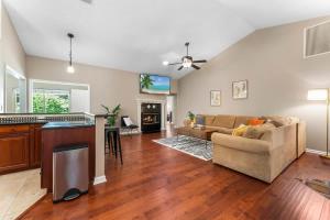 a living room with a couch and a kitchen at Costal Lane - Main in Jacksonville