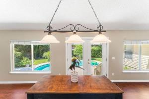 a dining room with a table and three lights at Costal Lane - Main in Jacksonville