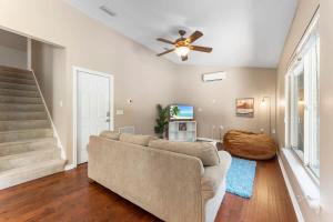 a living room with a couch and a ceiling fan at Costal Lane - Main in Jacksonville +49 photos