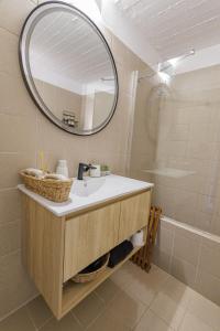 a bathroom with a sink and a mirror and a tub at Pasithea Sunset in Milopótamos +46 photos