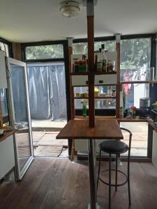 a kitchen with a table and a stool in a room at Le Loft in Montpellier