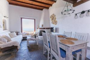 a living room with a table and a couch at Pasithea Sunset in Milopótamos