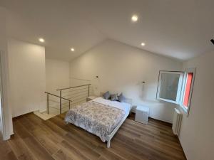 a bedroom with a bed and a staircase in it at Casa Gina in Chioggia