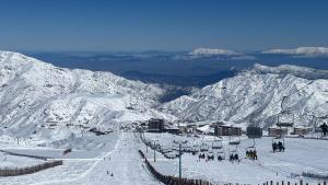 a group of people on a snow covered ski slope at Loft Ski el Colorado in Santiago