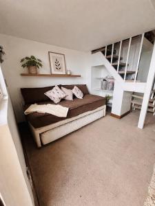 a bedroom with a bed with pillows and a staircase at Loft Ski el Colorado in Santiago