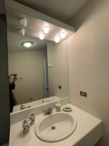 a bathroom with a sink and a large mirror at Loft Ski el Colorado in Santiago