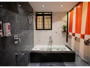a bathroom with a bath tub in a room at Hotel Venus Inn in Indore +15 photos