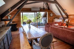 a living room with a wooden table and a couch at Une demeure d'exception au cœur des Alpes du Sud in Venterol