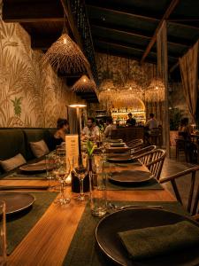a long wooden table in a restaurant with glasses at CasaBosque in Tarapoto