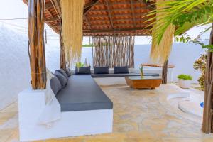 a pavilion with a couch and a table at Hotel Pousada 360 in Paracuru