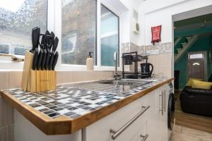 a kitchen with a sink and a counter top at 2Bd Mid Terrace Close To Station in Stoke on Trent +11 photos
