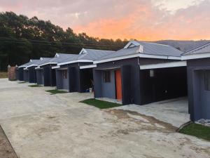 a row of houses parked in a lot at Qten Camp in Pietermaritzburg