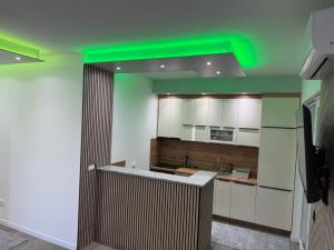 a kitchen with a green ceiling and white cabinets at Villa Lux Una in Bosanska Krupa