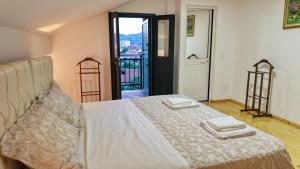 a bedroom with a bed with two towels on it at Dua 1 Apartments Shkoder in Shkodër