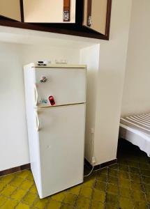 an old white refrigerator in a corner of a room at Lido del Sole bilo 28 in Rodi Garganico