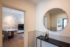 a living room with a mirror and a dining room at Boutique Suites in Lugano +72 photos