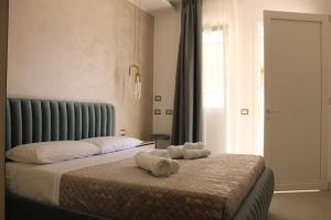 a bedroom with a bed with towels on it at Aurea Rooms in Porto Cesareo