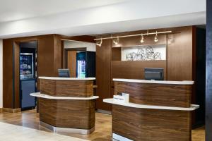 a lobby with wood paneling and a reception desk at Courtyard Memphis Germantown in Memphis +41 photos