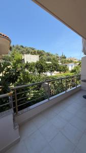 a balcony with a railing and a view of a city at Villa MarJon in Vlorë