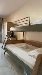 a bedroom with two bunk beds in a room at Villa MarJon in Vlorë