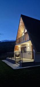 a building with a balcony on the side of it at Veruša - Maksim's house in Veruša