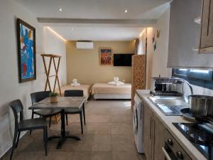 a kitchen with a table and a living room at Villa Don Kostangelo in Nikiana