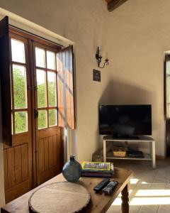 a living room with a tv and a coffee table at Monte da Azinheira in Ourique