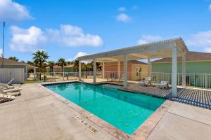 a swimming pool with a gazebo at Gone Coastal Cottage in Rockport