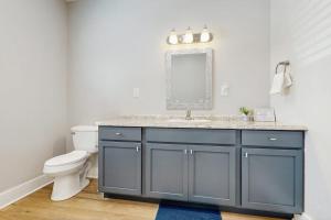 a bathroom with a sink and a toilet at Gone Coastal Cottage in Rockport +9 photos