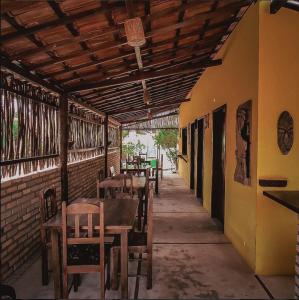 a row of tables and chairs in a restaurant at Pousada Caravelas in São Miguel do Gostoso